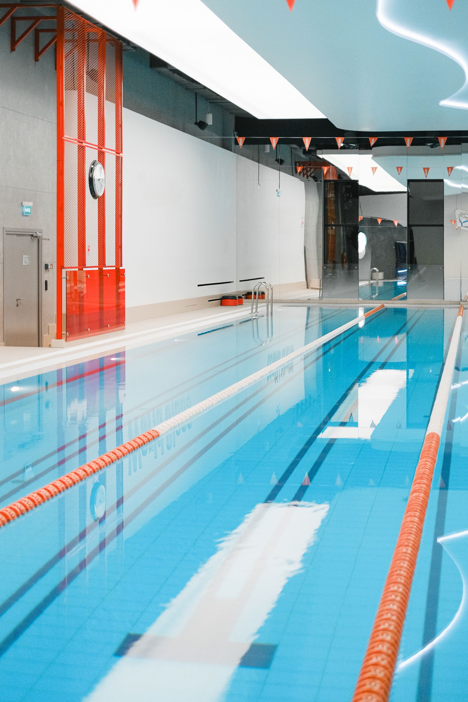Bright indoor swimming pool with lanes for swim lessons